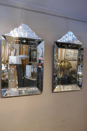 A decorative pair of 1930's continental Venetian style mirrors with crests .
