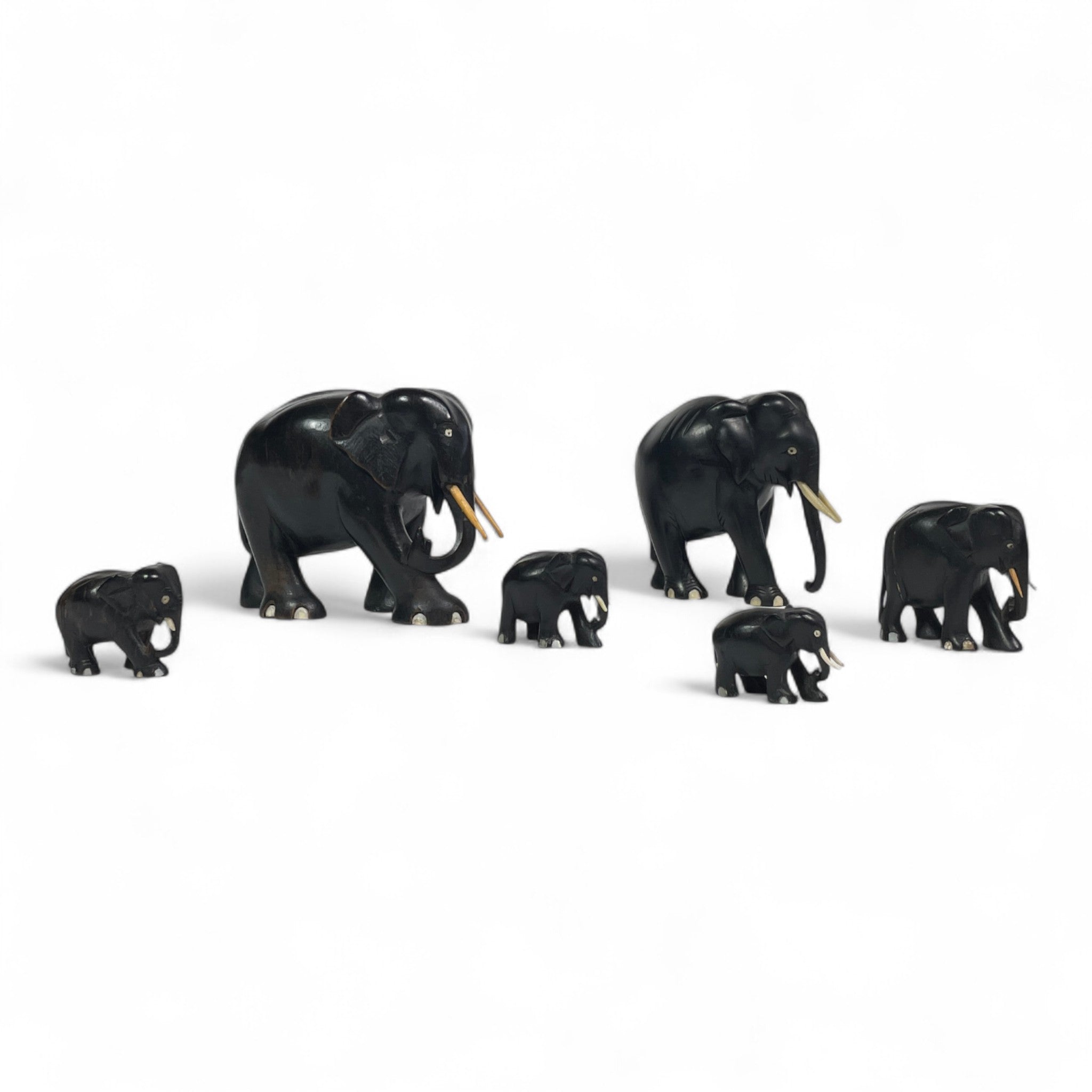 Group of early twentieth century Ebony elephants with bone details.