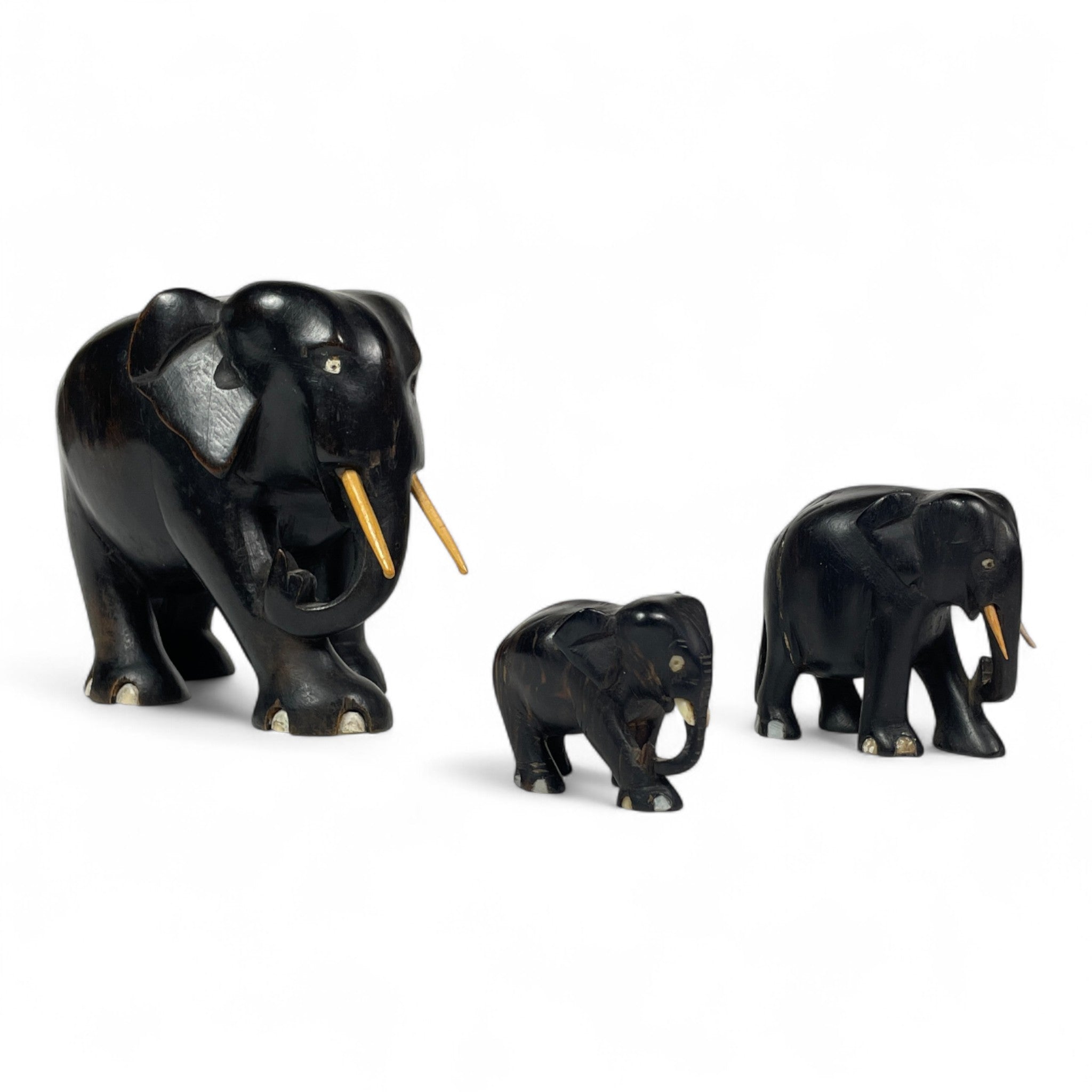 Group of early twentieth century Ebony elephants with bone details.