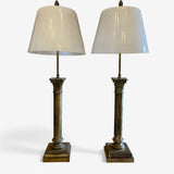 Classical pair of brass table lamps with tapered white glass shades.