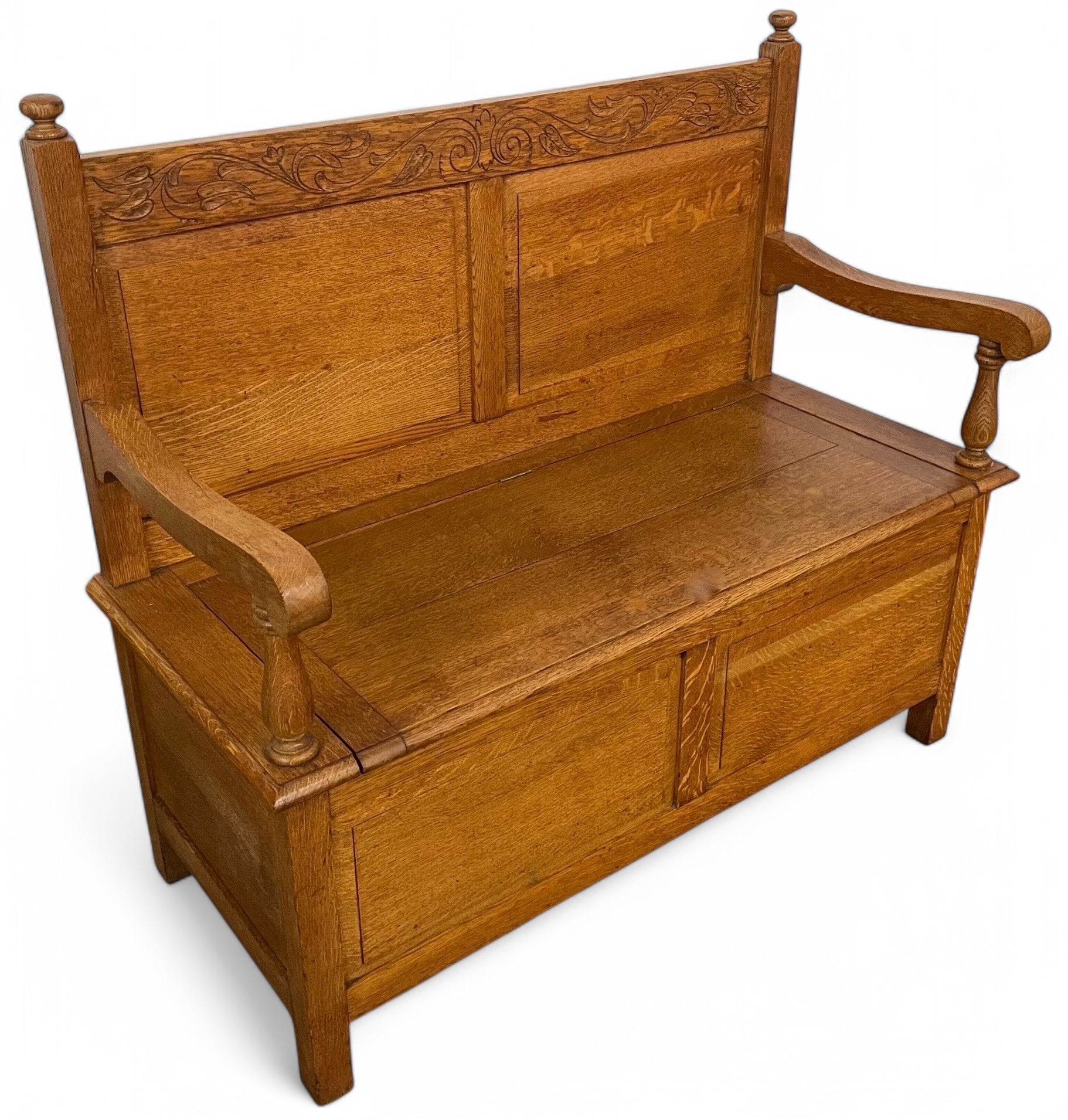 A twentieth century Cotswold style carved oak settle .