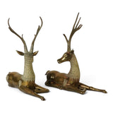 Large pair of mid century solid brass recumbent deer.