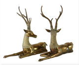 Large pair of mid century solid brass recumbent deer.