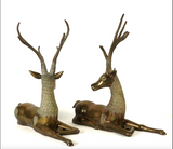 Large pair of mid century solid brass recumbent deer.