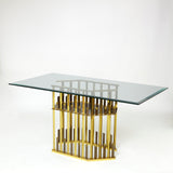Geometric gold table base of superb quality with glass top .