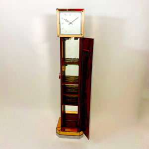 A mirrored Art Deco cocktail cabinet modelled as a long case clock .