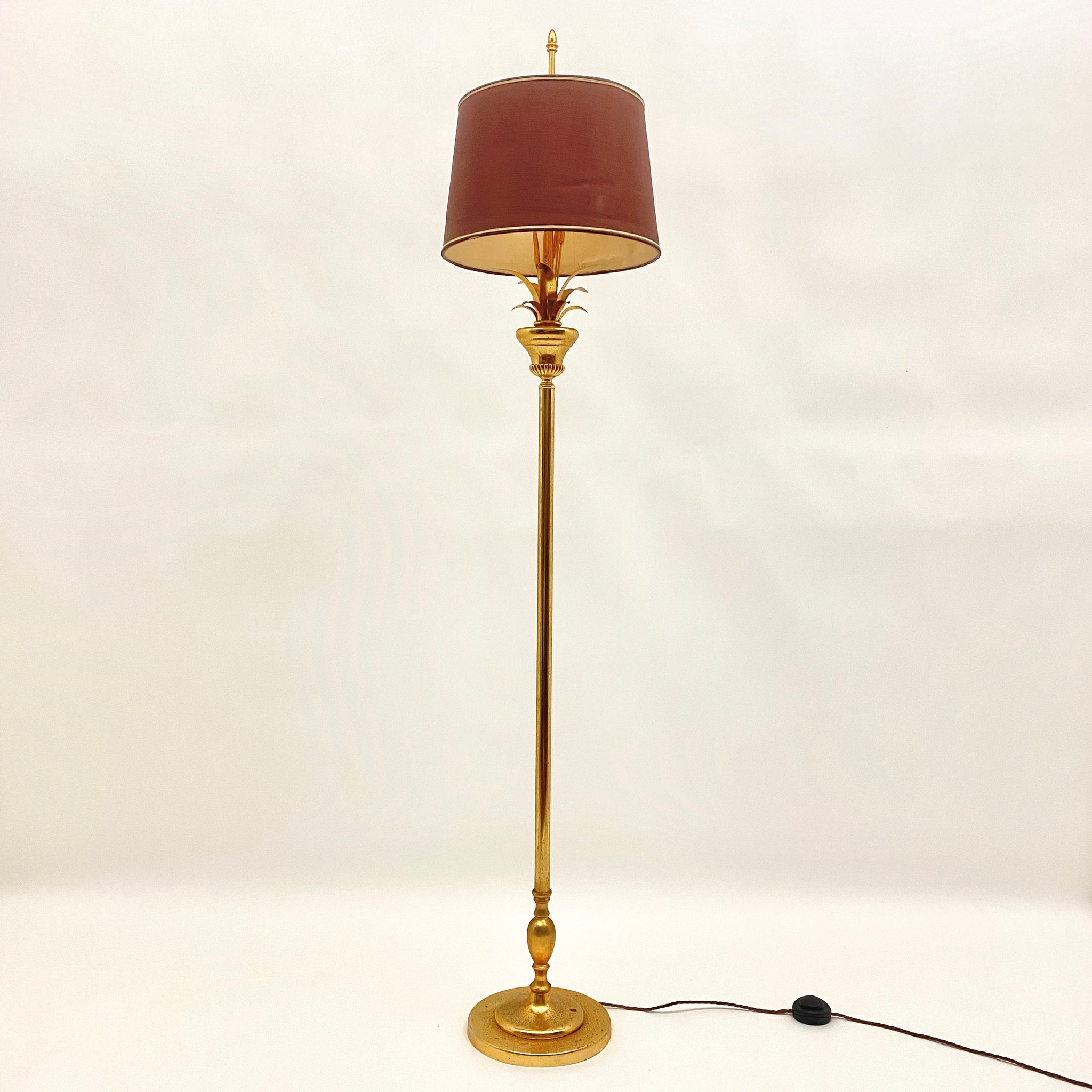 Gilt metal floor lamp in the style of Maison Charles.
