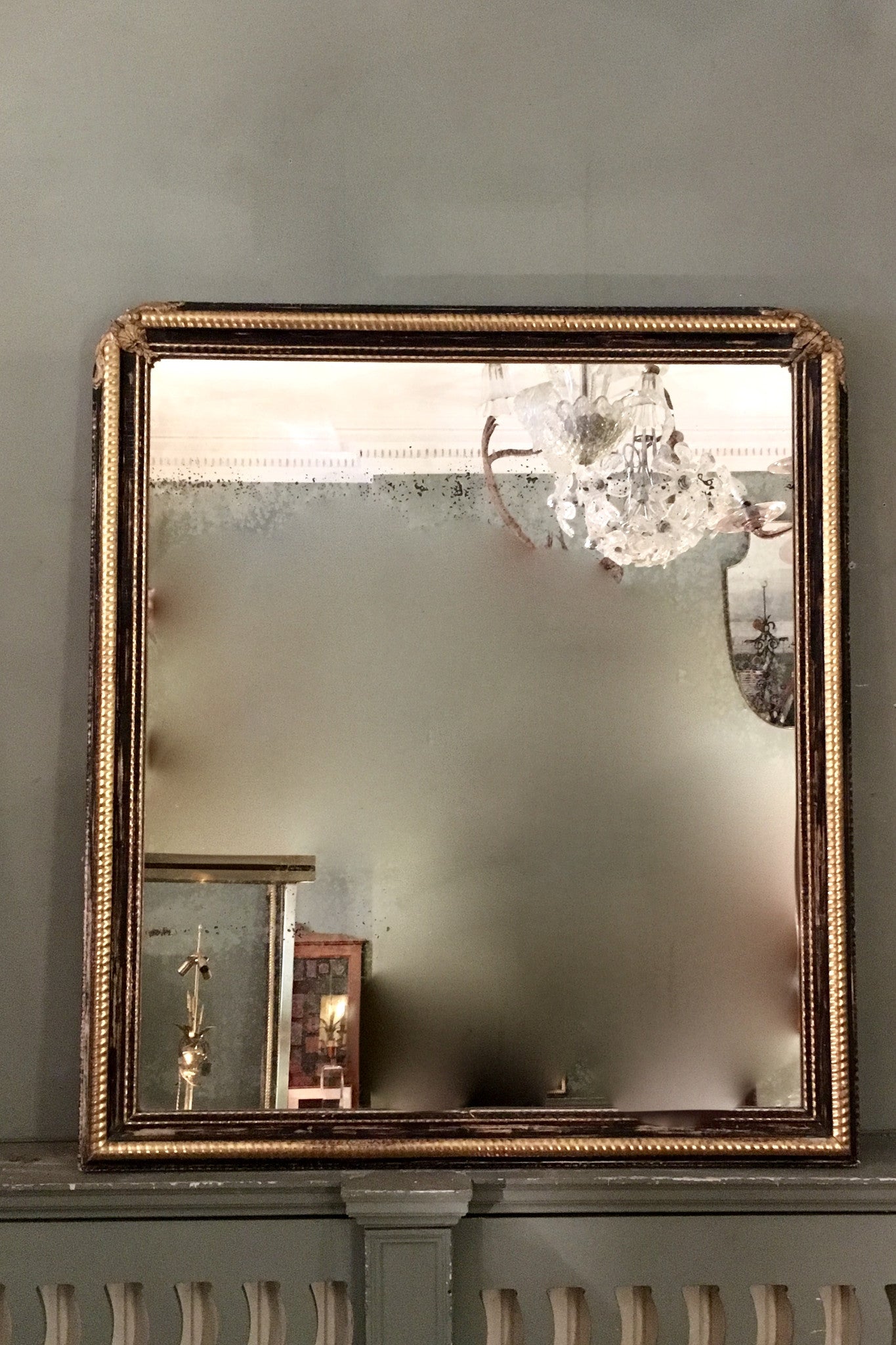 X 19th century french mirror with part gilt and ebonised frame with original distressed mirror.