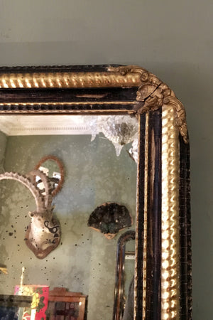 X 19th century french mirror with part gilt and ebonised frame with original distressed mirror.
