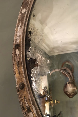 X A 19th century oval highly distressed 'Miss Haversham" style mirror.