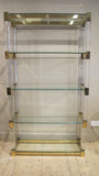 X An impressive perspex shelving unit with 50 mm perspex uprights and heavy gauge bronze frame .