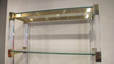 X An impressive perspex shelving unit with 50 mm perspex uprights and heavy gauge bronze frame .