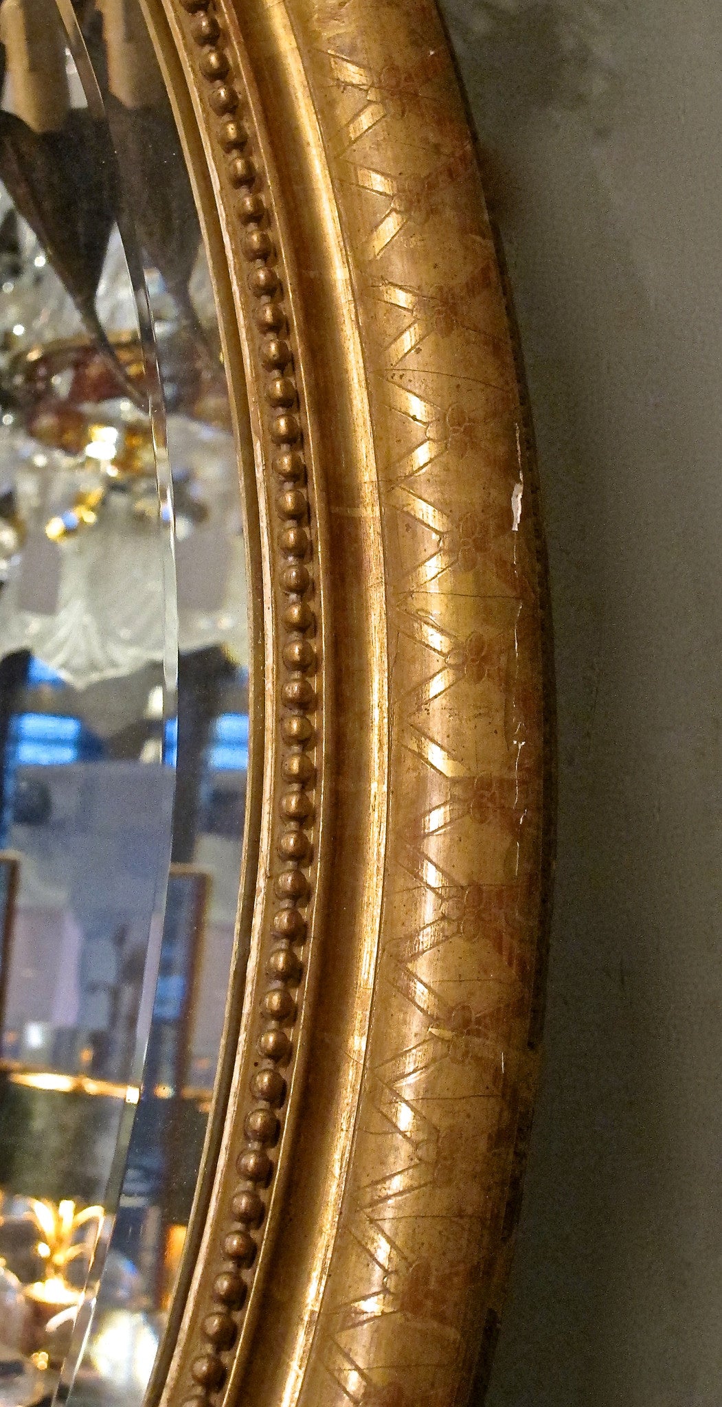 X A pretty gilt oval french mirror  with decorative crest.