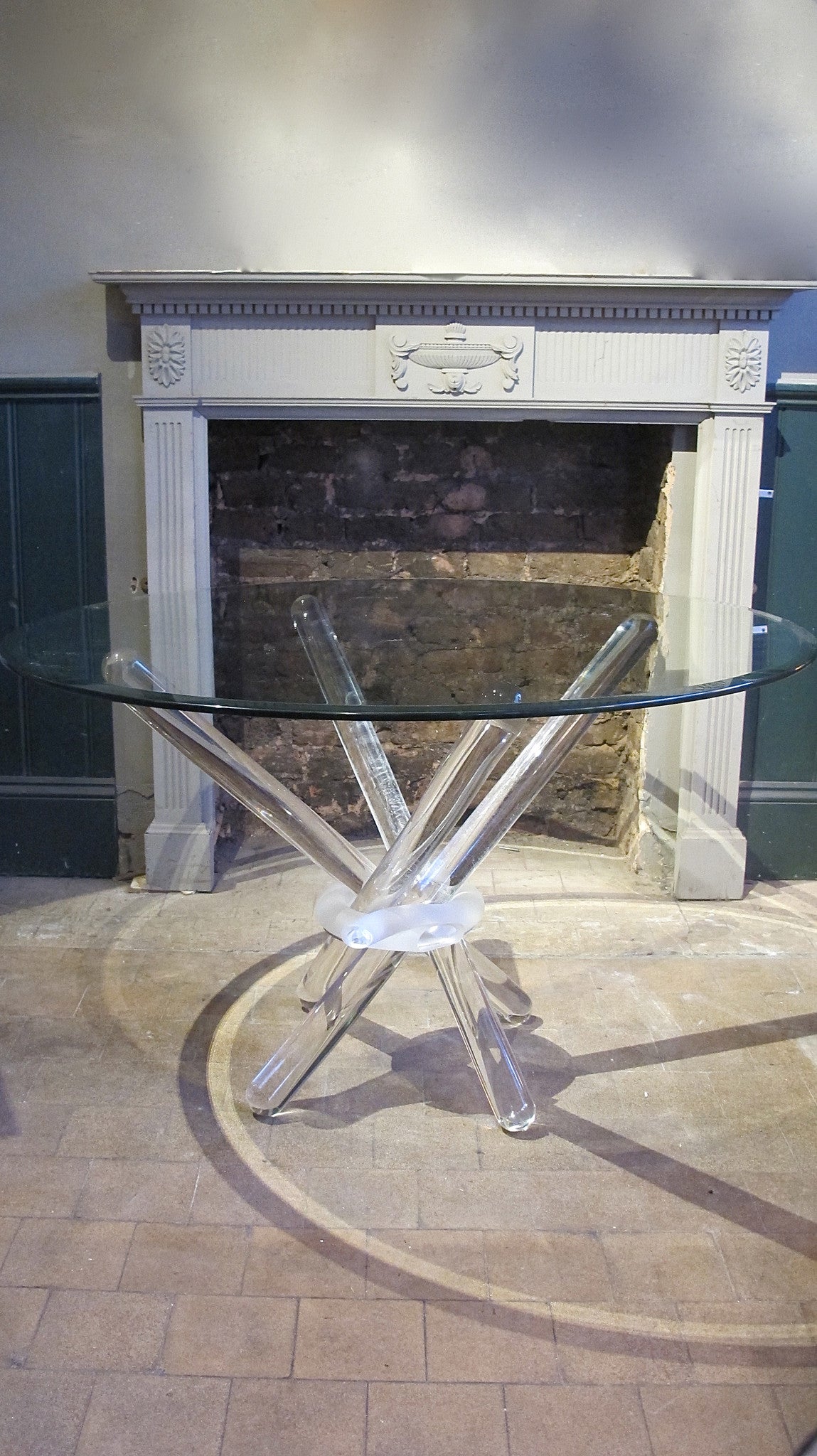 X A late twentieth century dinning table consisting of four solid glass legs held together with a glass ring.