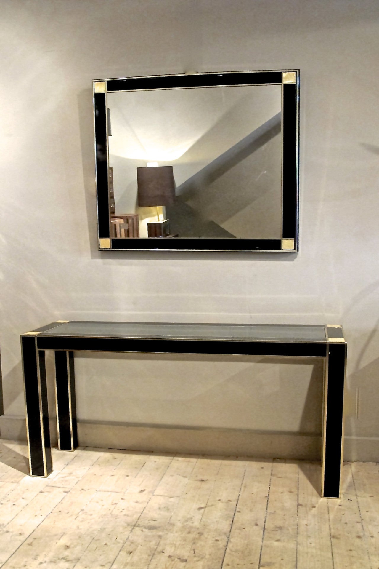 X A superb quality black lacquer console and mirror with solid brass trim and mother of pearl corner details.
