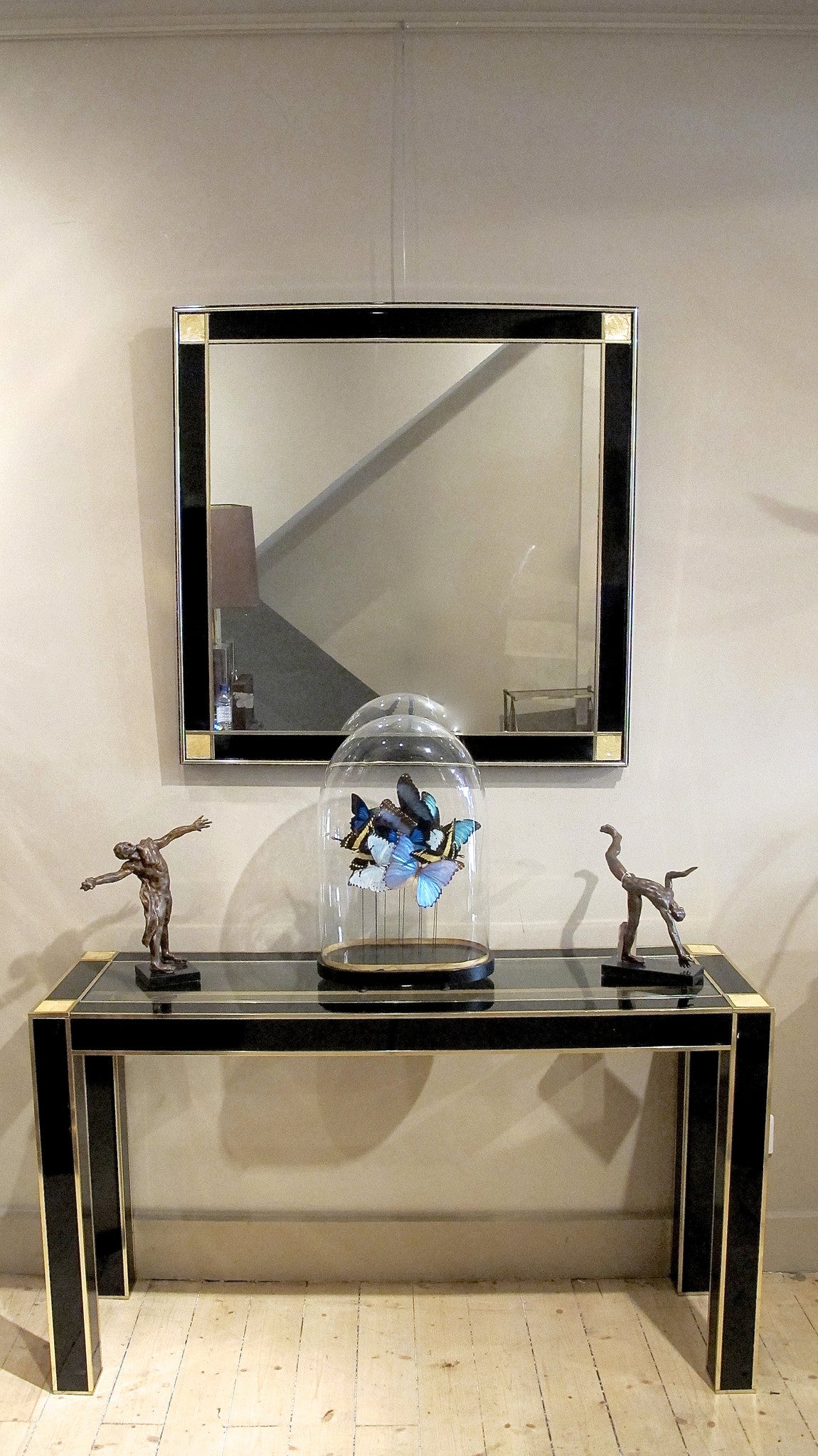 X A superb quality black lacquer console and mirror with solid brass trim and mother of pearl corner details.
