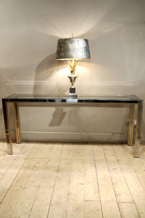 A large chrome 1970s console with brass edge detail