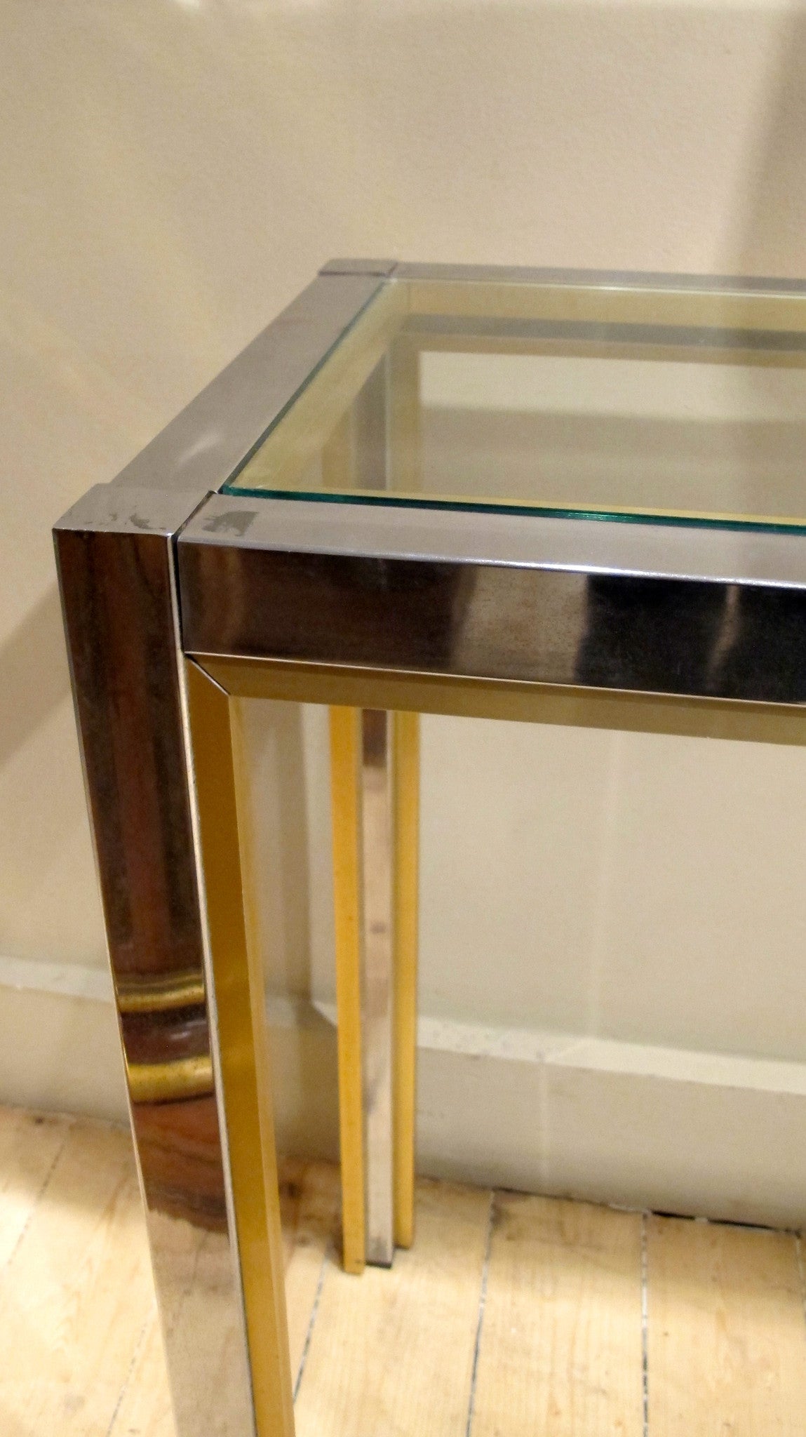 A large chrome 1970s console with brass edge detail