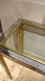A large chrome 1970s console with brass edge detail