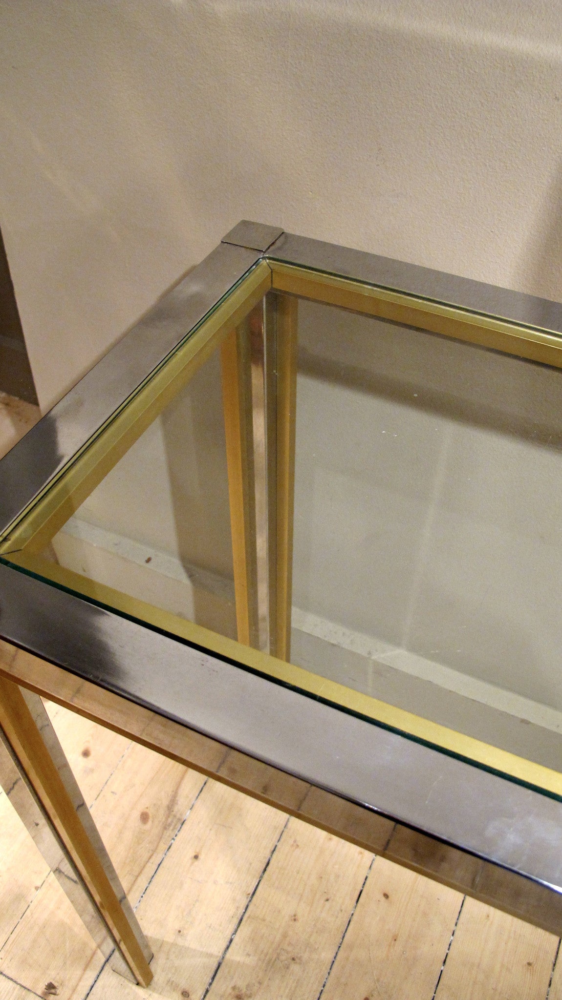 A large chrome 1970s console with brass edge detail