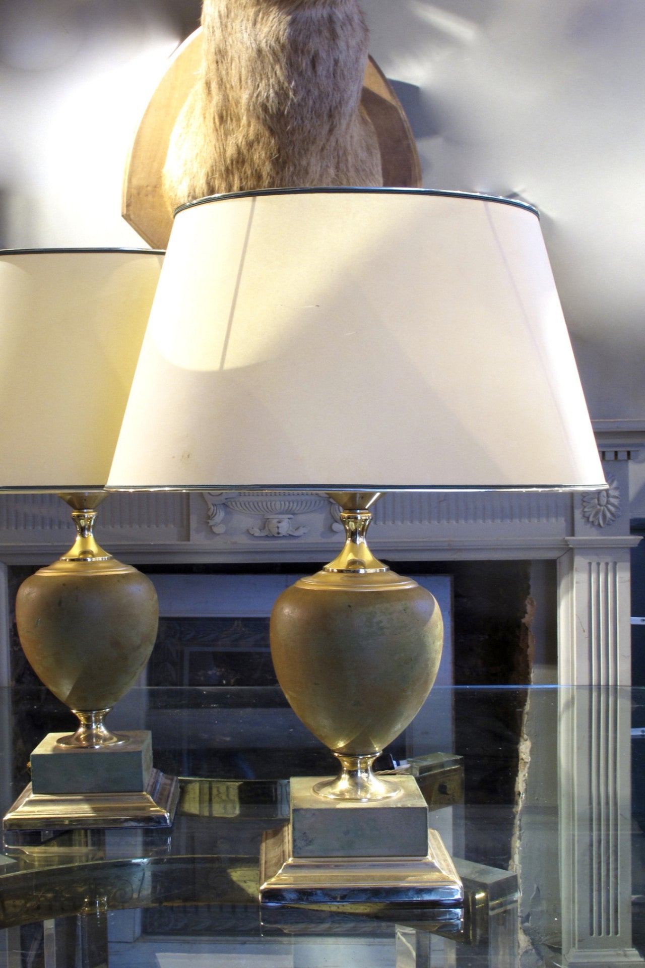 X a pair of 1970s leather wrapped table lamps with brass bases.