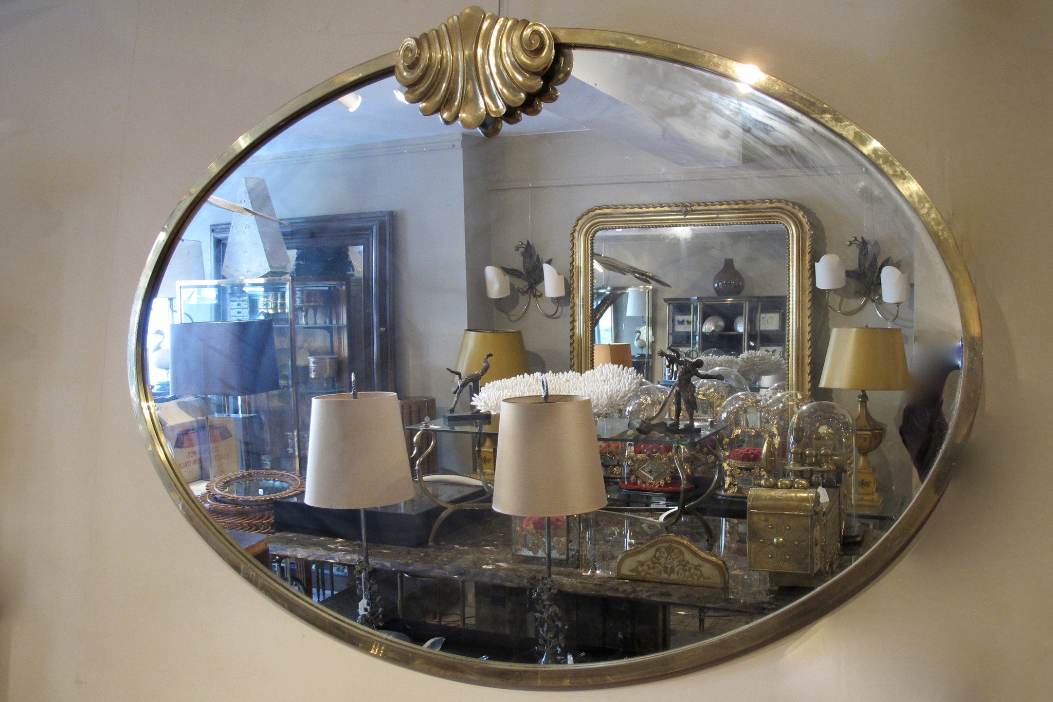 X A large 1960s oval brass framed italian mirror.