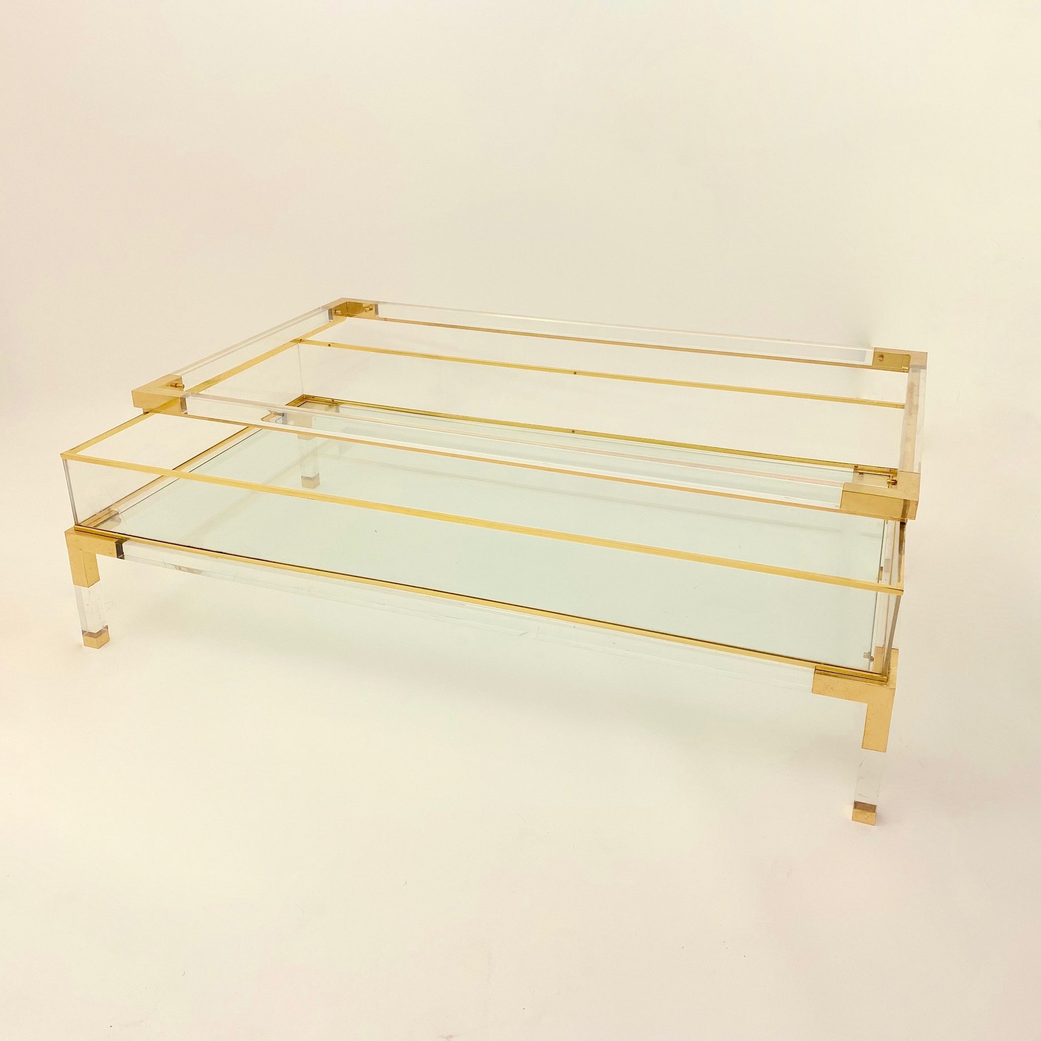 Vintage French perspex and brass coffee table with sliding top .