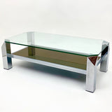 Vintage modernist 2 tier chrome coffee table with canted corners .