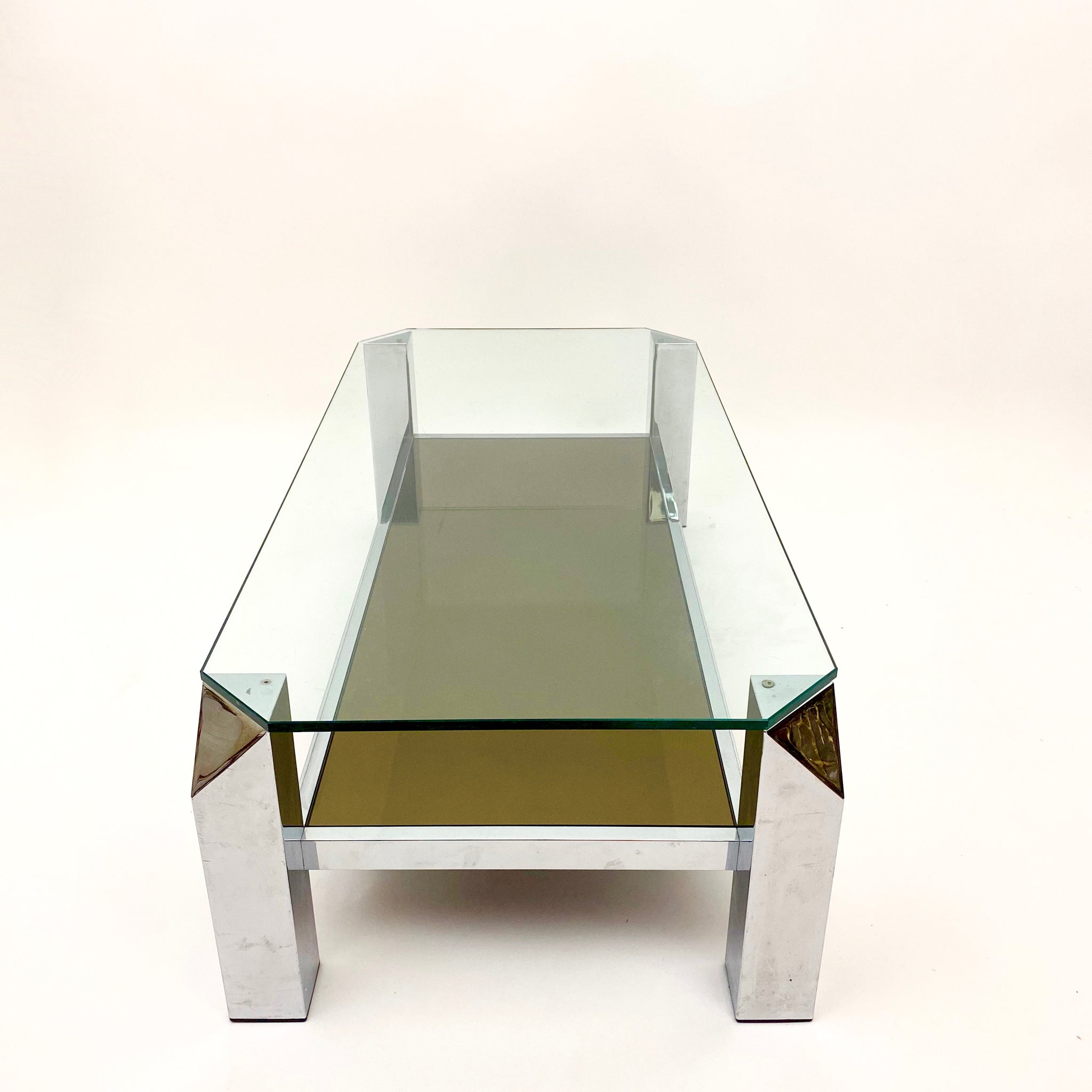 Vintage modernist 2 tier chrome coffee table with canted corners .