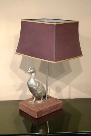 X A 1970s table lamp modelled as a duck on a velvet base.