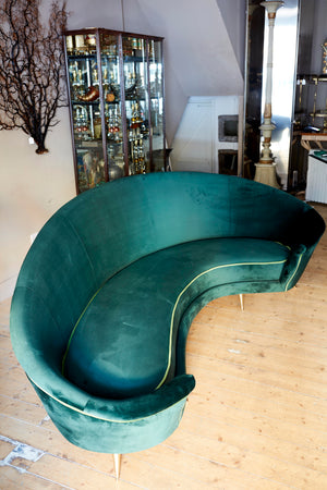 Italian curved 50's style sofa newly upholstered in green velvet.