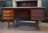 Teak Danish kneehole desk circa 1960 with two banks of three drawers and rear open bookcase . .