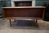 Teak Danish kneehole desk circa 1960 with two banks of three drawers and rear open bookcase . .