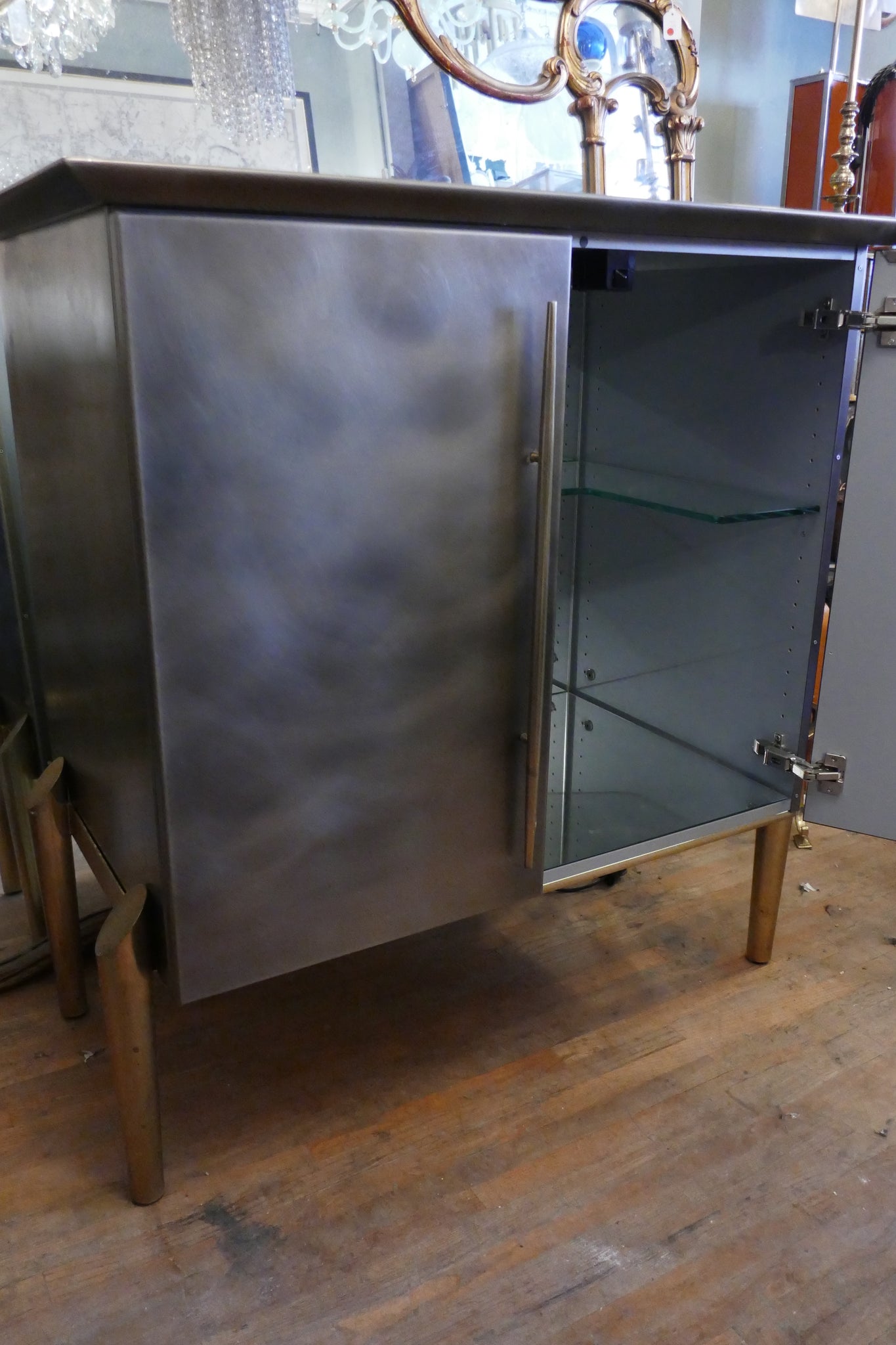 Steel and brass cocktail bar with mirrored interior circa 1970 .