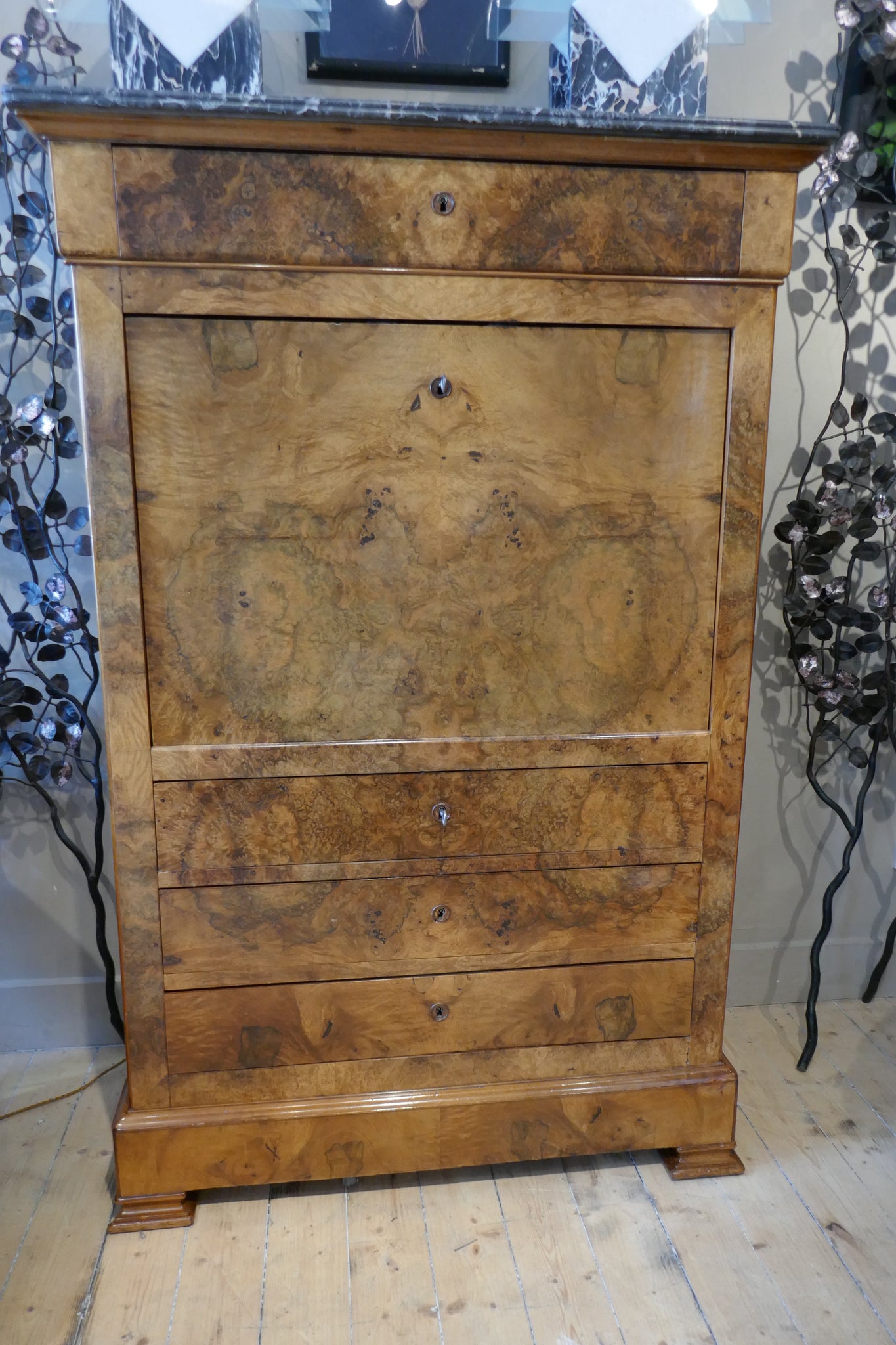 Elegant Biedermeier secretaire with variegated marble top .