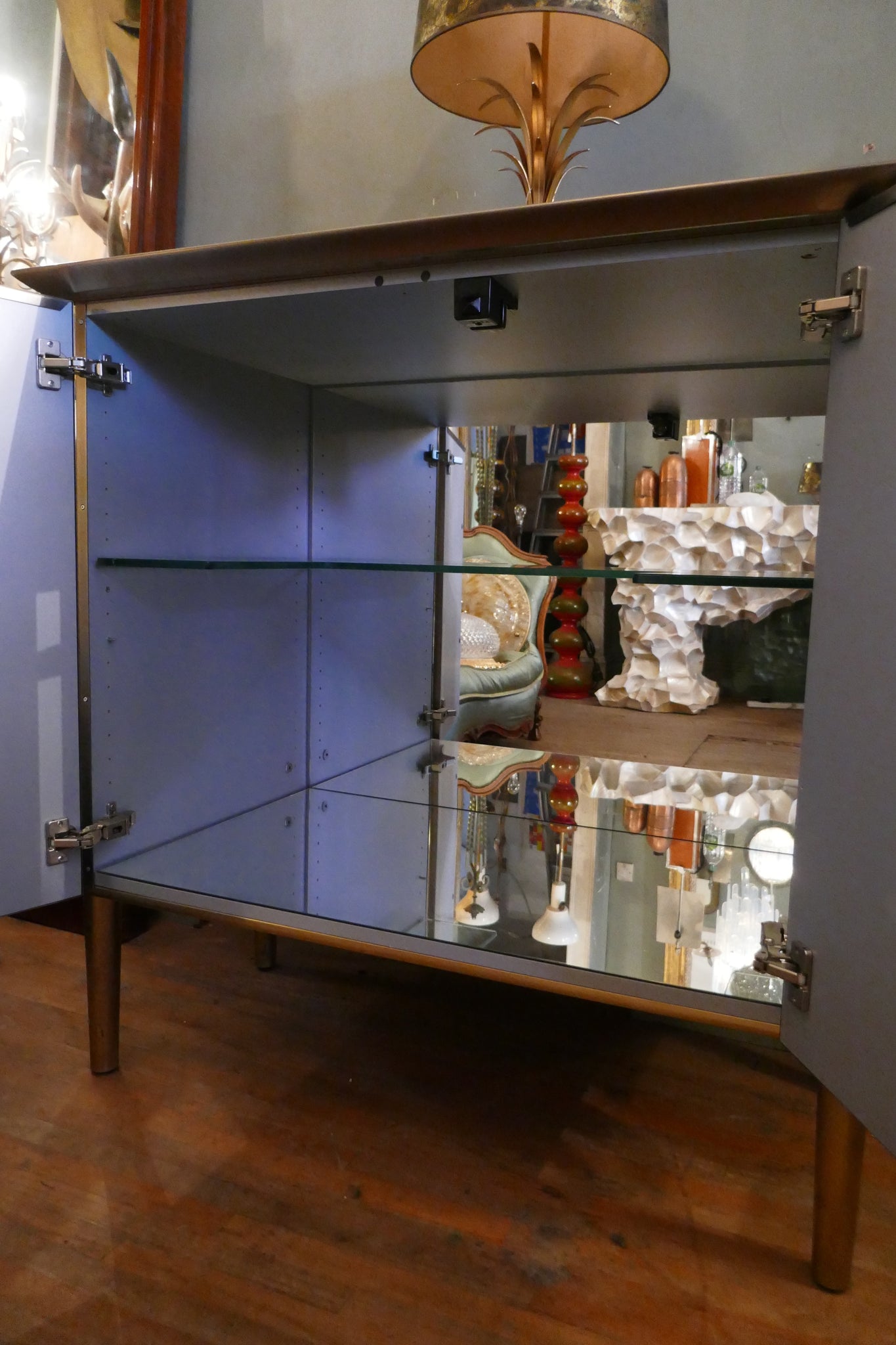 Steel and brass cocktail bar with mirrored interior circa 1970 .