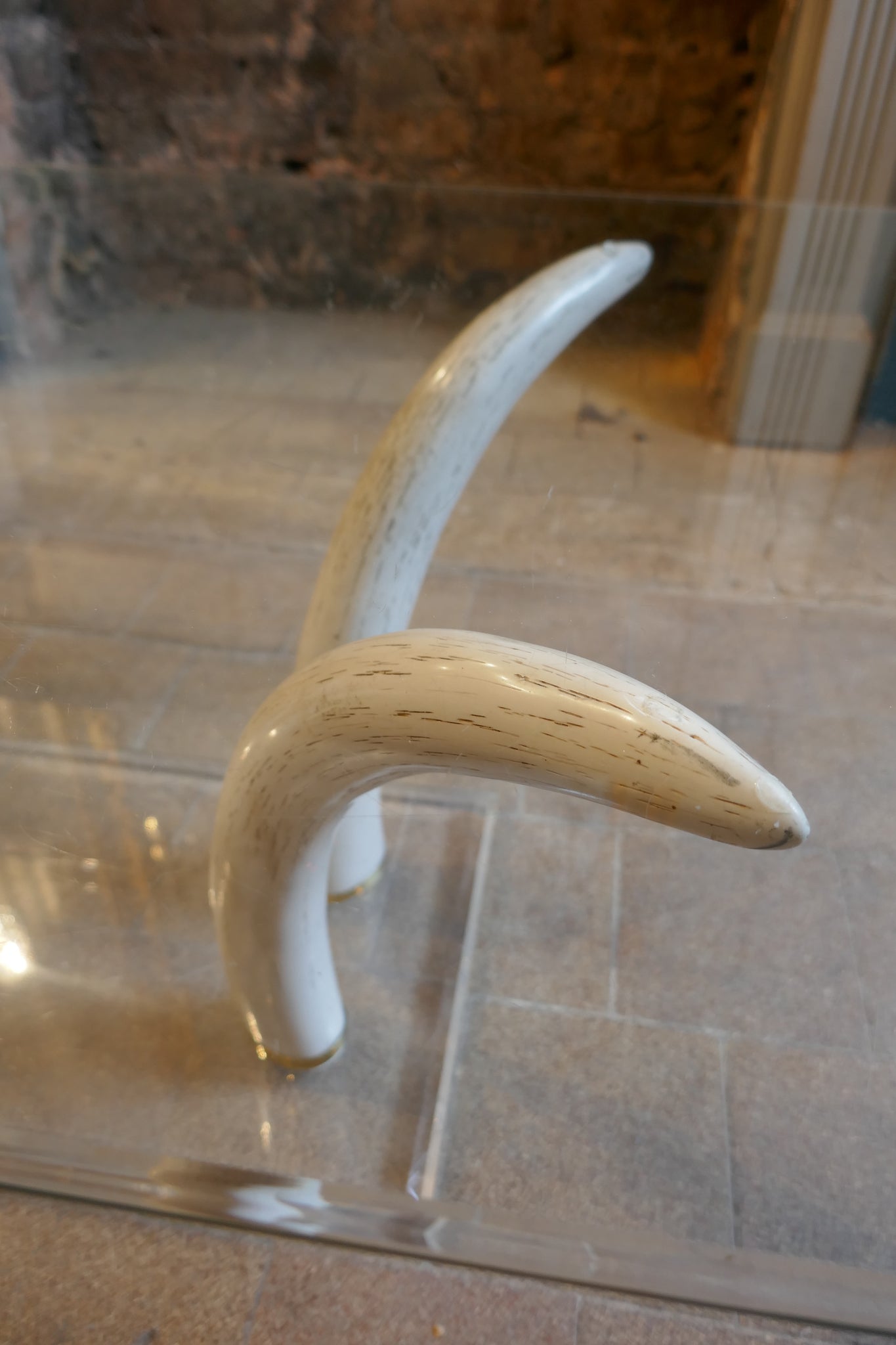 Decorative 1970's coffee table with RESIN faux tusk supports .