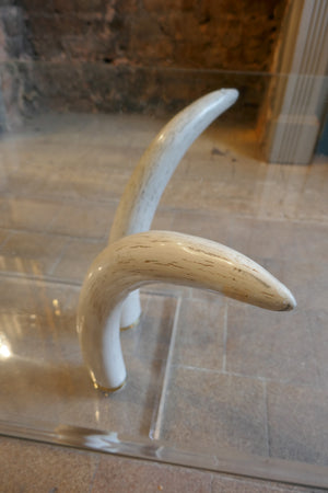 Decorative 1970's coffee table with RESIN faux tusk supports .