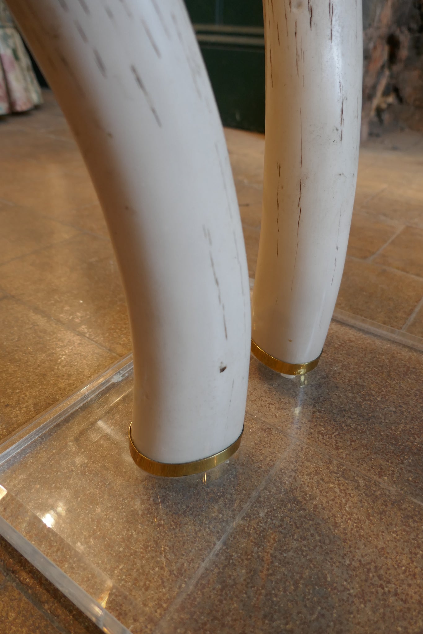 Decorative 1970's coffee table with RESIN faux tusk supports .