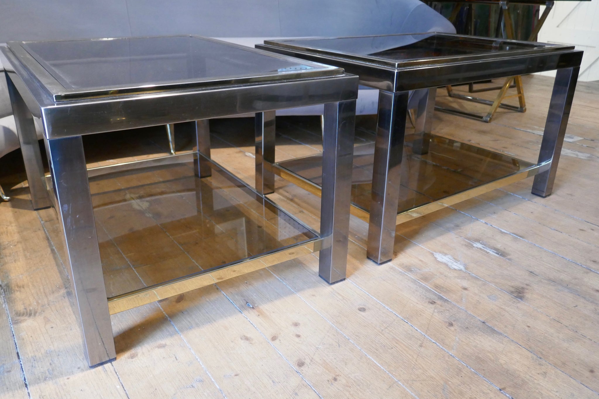 Pair of 1970's chrome and gold side tables in the manner of Willy Rizzo.