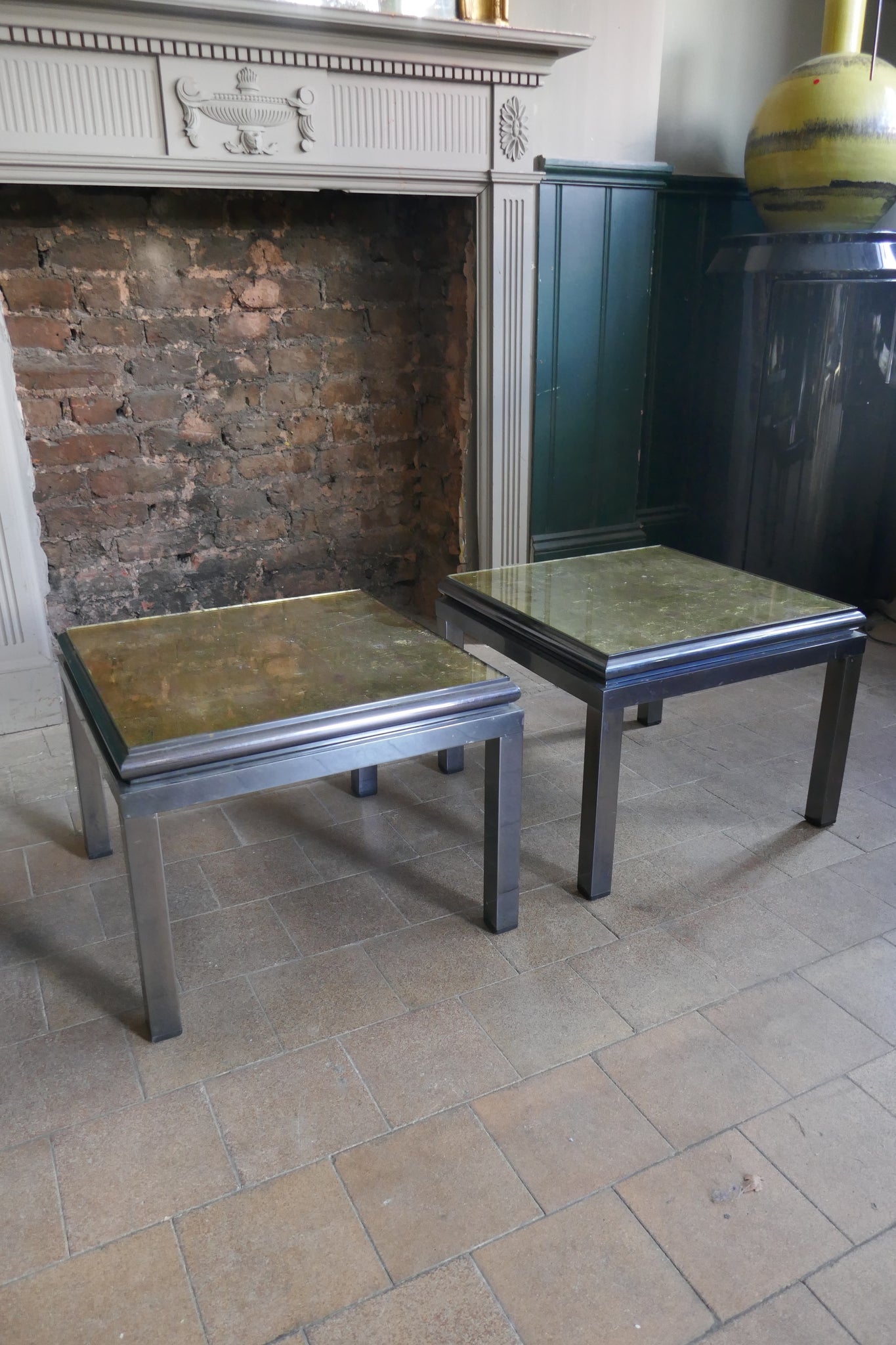 Pair of 1970's steel side tables with gold Verre Eglomise  tops .