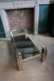 a 1970's modernist gold plated rectangular coffee table with chamfered corners .