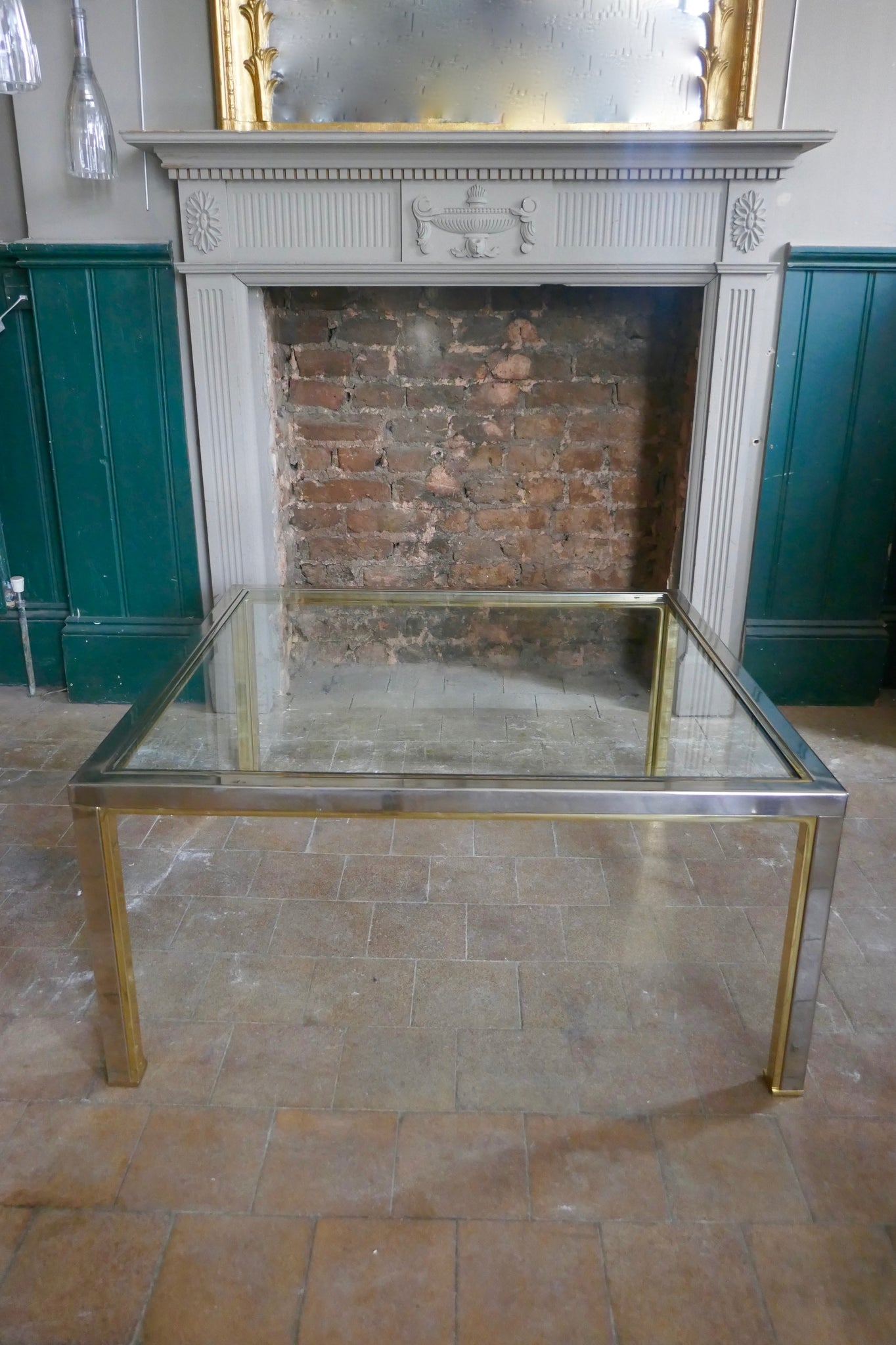 a 1970's chrome and gold coffee table with two undertables in the Romeo Rega style
