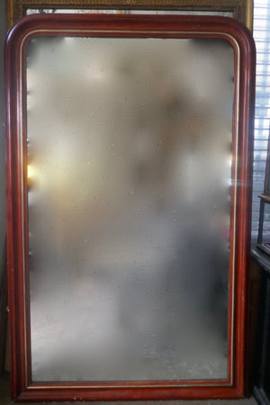 Large and decorative French mirror with original glass and parcel gilt frame circa 1900.