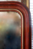 Large and decorative French mirror with original glass and parcel gilt frame circa 1900.