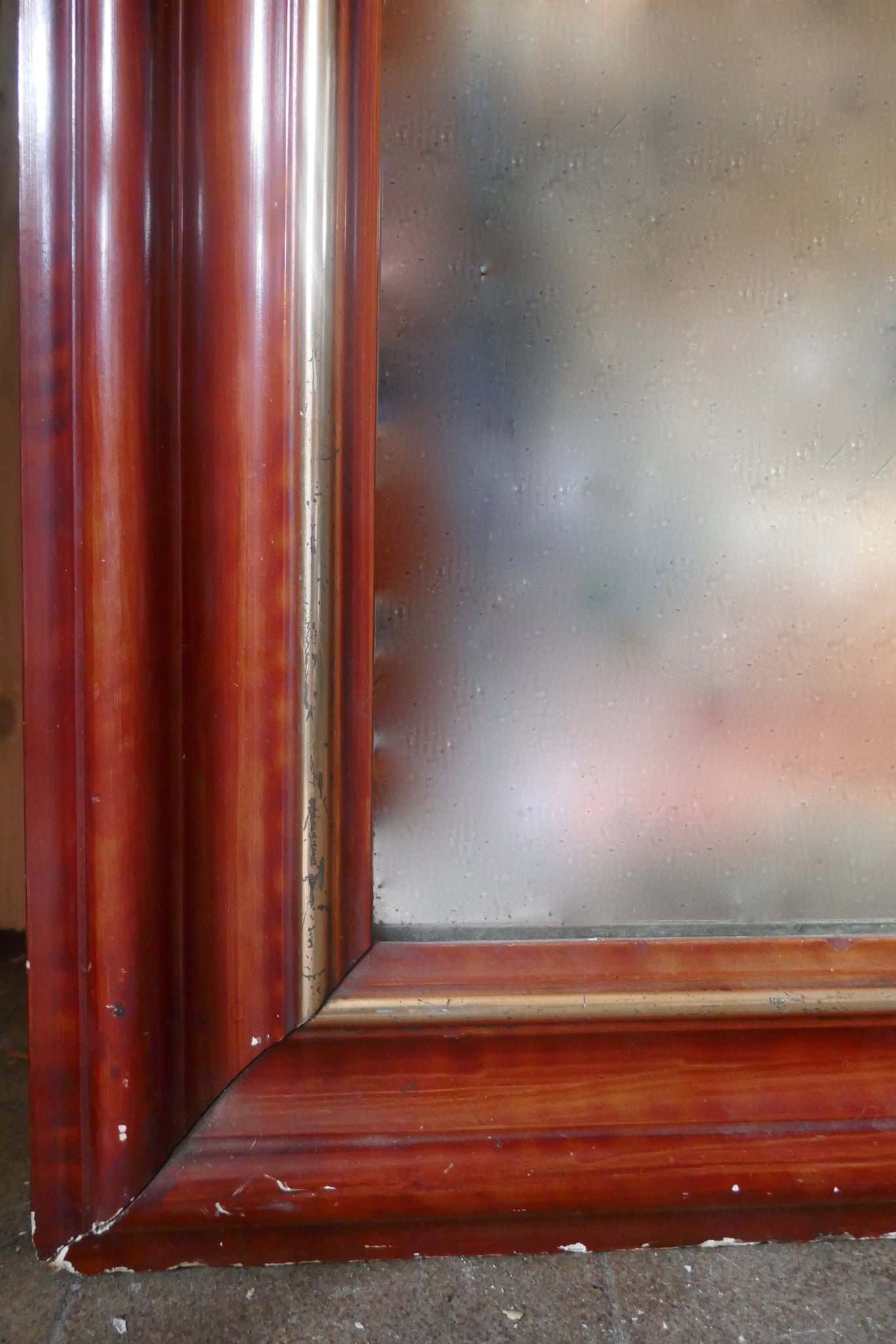 Large and decorative French mirror with original glass and parcel gilt frame circa 1900.