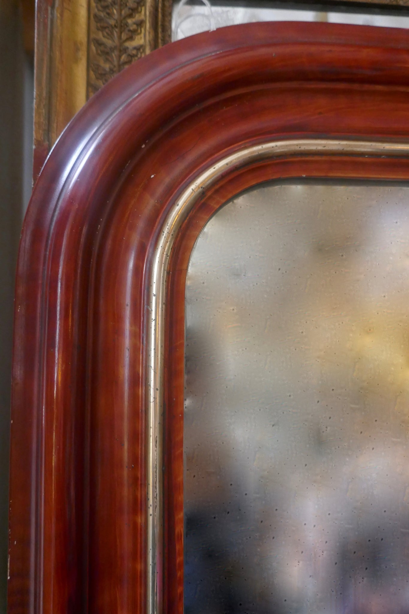 Large and decorative French mirror with original glass and parcel gilt frame circa 1900.